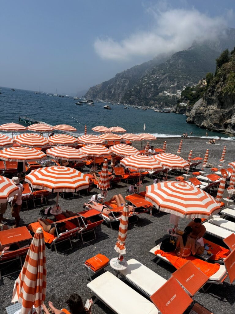 Iconic orange and white striped umbrellas at Arienzo Beach Club in Positano
