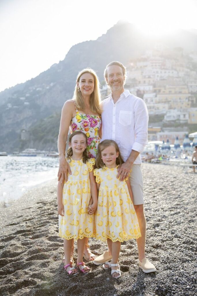 Family of four on Positano beach at golden hour during their Amalfi Coast trip