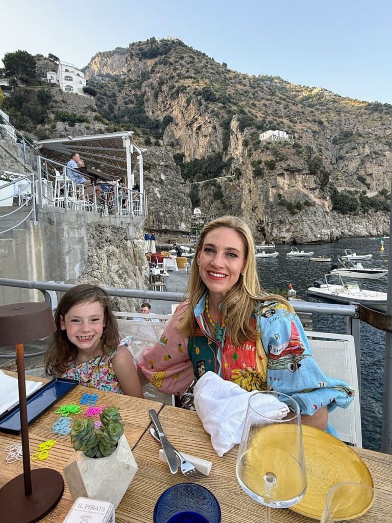 Cliffside view from Il Pirata restaurant in Praiano with boats and the Amalfi Coast in the background