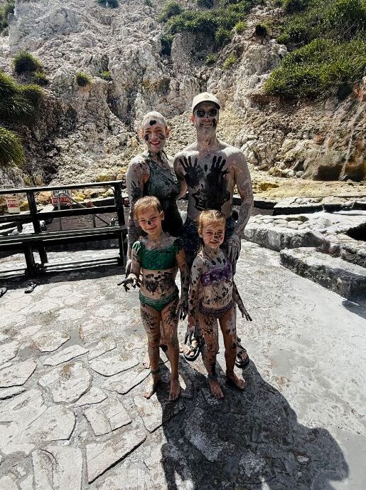 Family of four covered in volcanic mud at Sulphur Springs, the Caribbean's only drive-in volcano, in St. Lucia