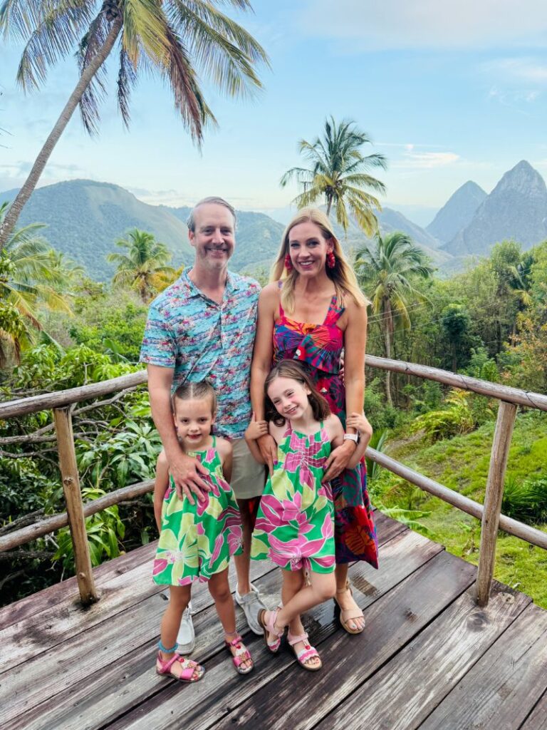 Family of four dining at Treetop Restaurant at Crystals Resort in St. Lucia with the Pitons visible in the background.
